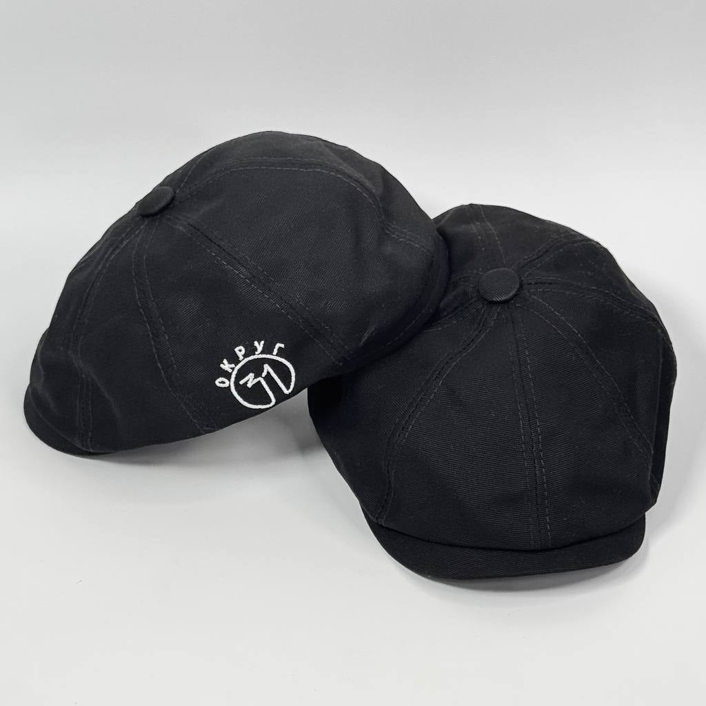 Two black caps with a logo on a white background