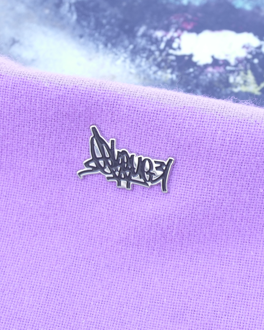 Purple fabric with a metallic pin on a textured surface 